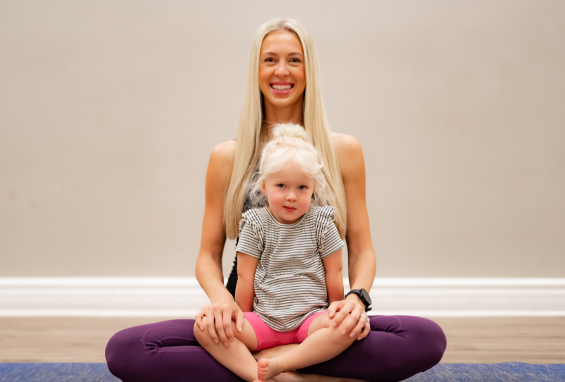 Mom with toddler on her lap for a mom and toddler reading class.